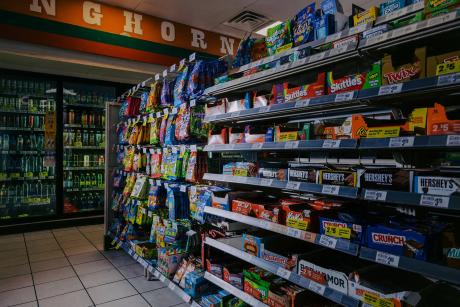 Candy bars and other sweets are displayed in the candy aisle of a convenience store in Austin on March 11, 2026. Beginning April 1, people will not be allowed to purchase candy and certain sweetened beverages using SNAP benefits.