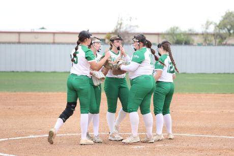 The Wall Lady Hawks huddle with pitcher Madee Williams during the 2026 softball season.