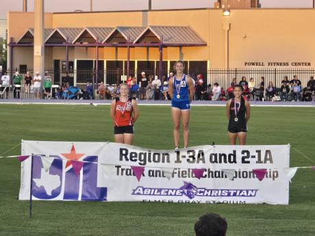 Veribest's Chloe Becker (center) won gold medals in the 100- and 200-meter dashes Saturday at the Region II-1A Track and Field Meet in Abilene.