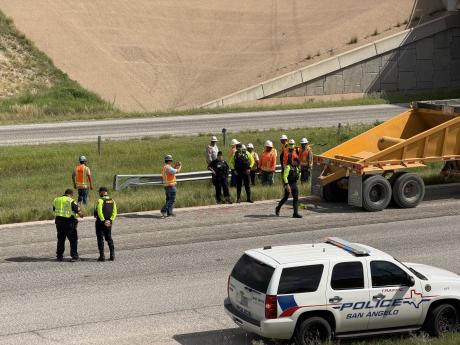 A road worker had his leg broken when he was backed over by a construction vehicle Tuesday morning on the Houston Harte Expressway.
