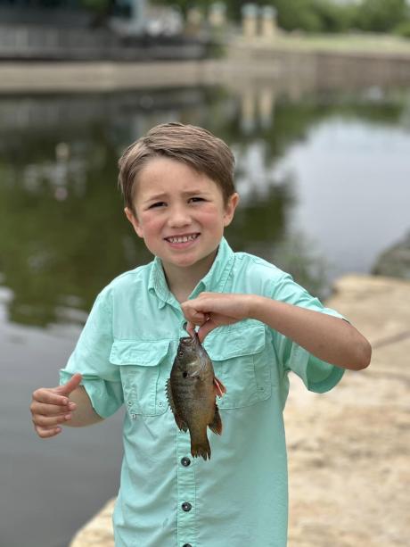 Kid caught a fish at fishing derby 