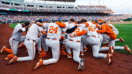 The Texas Longhorns huddle at the 2026 College World Series