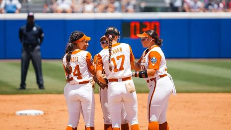 The Texas Longhorns softball team meets in the infield during the 2026 Women's College World Series.