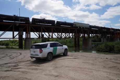 Border Patrol agents monitor the Rio Grande on May 11, 2026, after six bodies were found in a train boxcar in Laredo. 