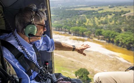 Gov. Greg Abbott surveys flooding during July, 2026.