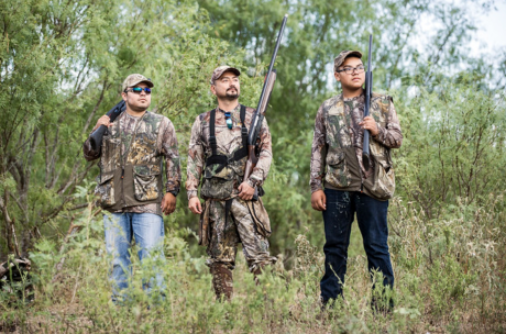 Three people are shown dove hunting.