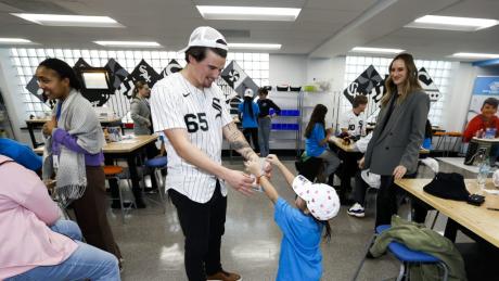 Chicago White Sox pitcher Davis Martin interacts with a young fan during the 2026 season.
