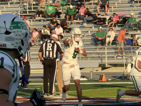 Wall quarterback Gunner King fires a pass in warmups before the Hawks' game against Llano on Friday, Oct. 9, 2026.
