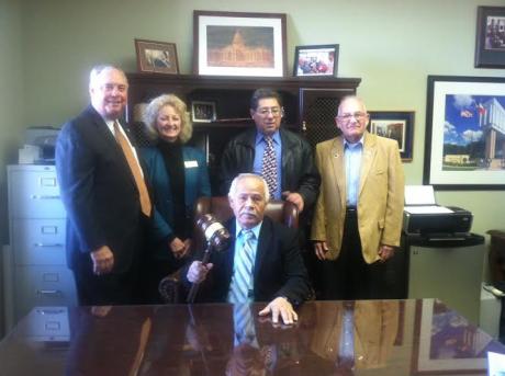 Gutierrez sits in the big chair with his gavel, surrounded by supporters (LIVE! photo by Cheyenne Benson)