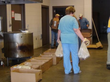 A Lions Club Member helps put briskets in bags (LIVE! photo by Cheyenne Benson)