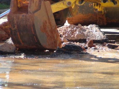 City workers break the asphalt to get to the main (LIVE! photo by Cheyenne Benson)