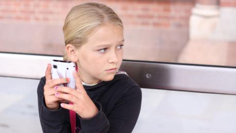 A young girl on her phone (photo courtesy of grandparents.com)