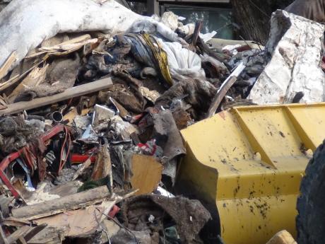 A front end loader scoops up debris (LIVE! photo by Cheyenne Benson)