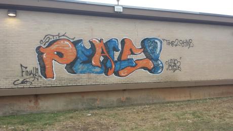 A vandal sending good vibes tagged Central High School with graffiti sometime Thursday night. (LIVE! Photo/John Basquez)