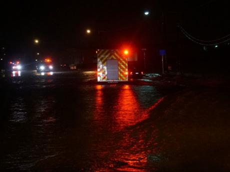 San Angelo Rescue approaches the stalled car in the middle of the overflowing Red Arroyo on S. Jackson St. at 1:50 a.m., May 25, 2014. (LIVE! Photo/John Basquez)