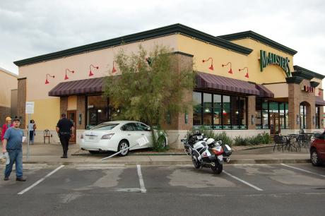 A car sits nestled up to the McCalister's facade, following an accidental crash. (LIVE! Photo by Chelsea Schmid)