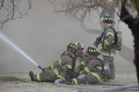 Firemen battle a house fire on Armstrong street Wednesday. (LIVE! Photo by John Basquez)