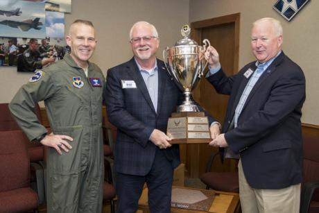 Mike Boyd, center, holding the 2019 award to San Angelo of the Altus Trophy for community support of an Air Force base.