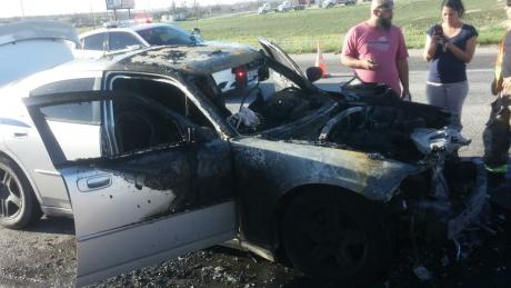 A Dodge Charger caught fire early Sunday evening on the frontage road to the Houston Harte Expressway on March 29, 2015. (LIVE! Photo/Amanda Henson)