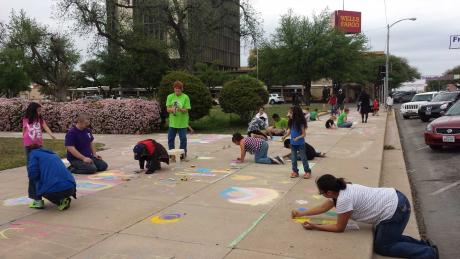Sidewalk chalk artists of all ages were scattered throughout the courtyard and sidewalks surrounding the courthouse busily creating masterpieces Apr. 11, 2015. (LIVE! Photo/Amanda Henson)