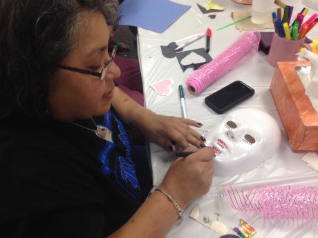Ruth Ruiz works on a mask that signifies how she felt losing her son, Aaron James Allen,  to a drunk driver. (LIVE! Photo/Chelsea Reinhard)