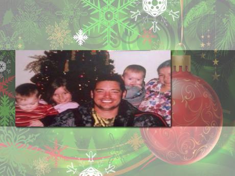 Brandon Lawson smiles with his children before their Christmas tree. (Photo courtesy of Facebook)