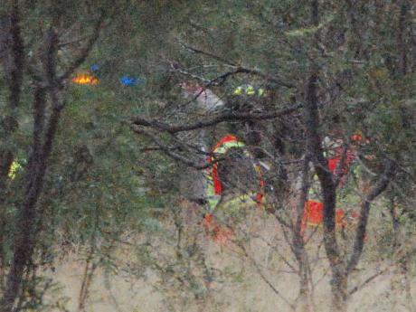 Rescue workers extracting the victim from the wreckage, about 50 yards into a Mesquite-covered field. (LIVE! Photo/Dylan Underwood)
