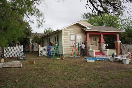 City employees paint houses on E. Harris St. as part of the annual blitz. (LIVE! Photo/John Basquez)