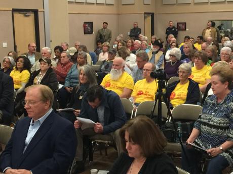 Lee Pfluger (left, blue suit). Behind him are protesters against his plan to build a sand depot on Hill St. (LIVE! Photo/Joe Hyde)