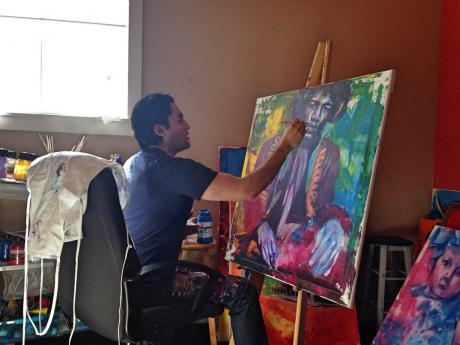 Alejandro Castanon works on a Jimi Hendrix portrait in his studio. (LIVE! Photo by Chelsea Schmid)