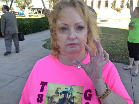 Karen Freeman holds up a pendant containing the ashes of her deceased daughter Tabitha, who was murdered on Sept. 1, 2013. (LIVE! Photo/Chelsea Reinhard)