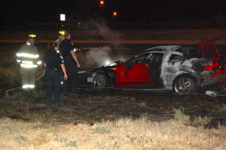 A woman driving a red Ford Mustang 500 GT spins out of control, crashes, and gets trapped inside burning vehicle. (LIVE! Photo/Joe Hyde)
