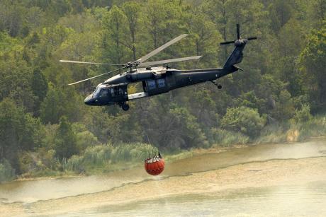 Texas National Guard helicopters battle wildfires in Bastrop in late 2011. (Contributed/Staff Sgt. Malcolm McClendon via Flickr)