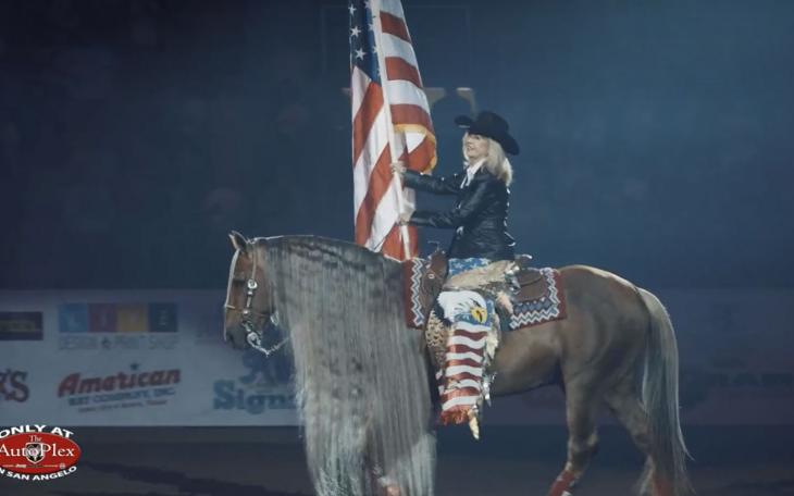 San Angelo Mayor Brenda Gunter presents the Stars and Stripes during the opening ceremony of the 10th Annual Cinch Chute Out