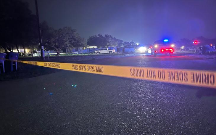 Crime tape blocking off a large area around the house where two law enforcement officers were gunned down the night of May 10, 2021 in Eden, Texas.