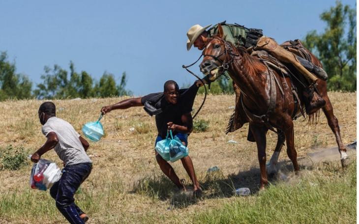 Border Patrol Agent Horseback Confronts Haitian (Contributed/Rueters)