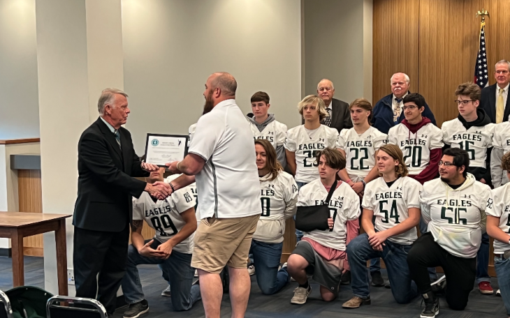 Tanner Thiel Accepting Certificate from Commissioner Rick Bacon