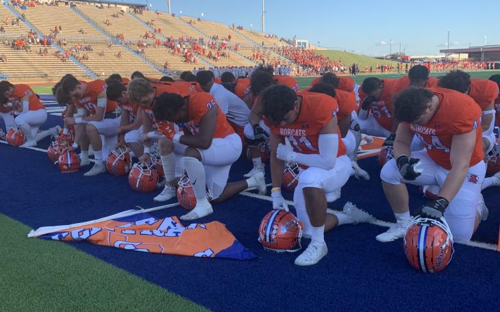 The San Angelo Central Bobcats pray before the game with the Belton Tigers