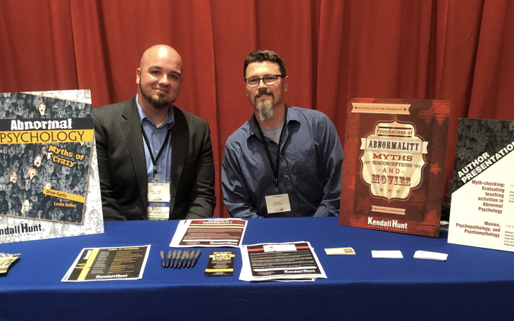 Dr. Drew Curtis (left) presenting his books at a SWPA Conference: