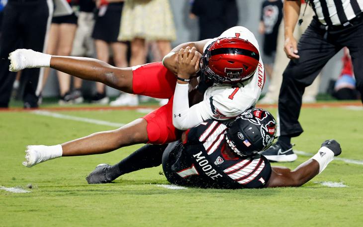 Texas Tech's Donovan Smith is sacked for a loss by North Carolina State's Isaiah Moore during the first half of an NCAA college football game in Raleigh, N.C., Saturday, Sept. 17, 2022. (AP Photo/Karl B DeBlaker)