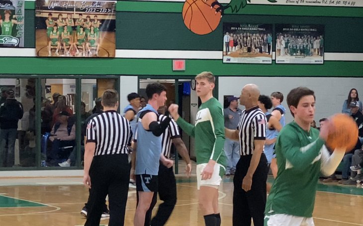 Wall's Everson Armstrong and TLCA's Drew Sherrill take notes from refs before their district game.