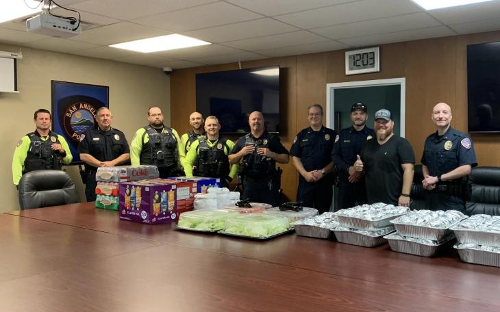 Lonestar Cheeseburger's proprietor Tim Condon, second from right, with members of the San Angelo Police Department.