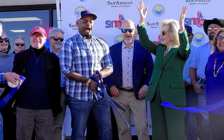 Mayor Brenda Gunter (center in green) celebrates the ribbon cutting of the new SMC expanded facility.