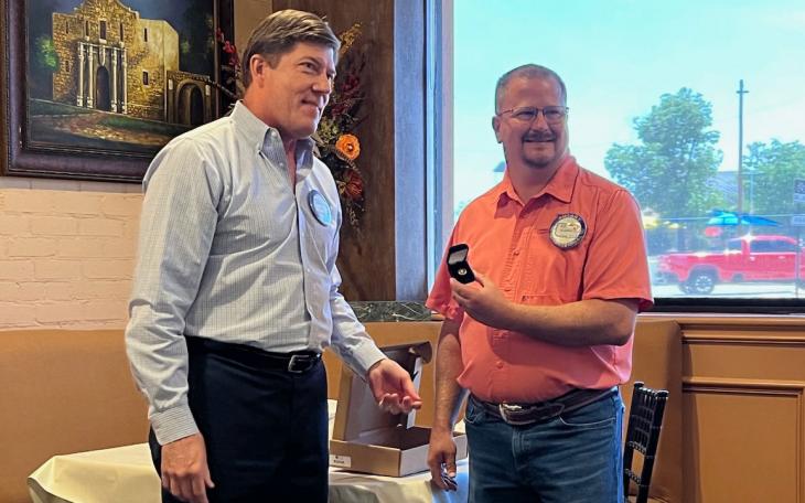 San Angelo Rotary President Ed Yale (L) presents Immediate Past President Devin Koehler with a pin signifying Devin's leadership for the past year.