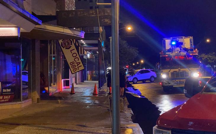 Sign on Downtown Building Falls