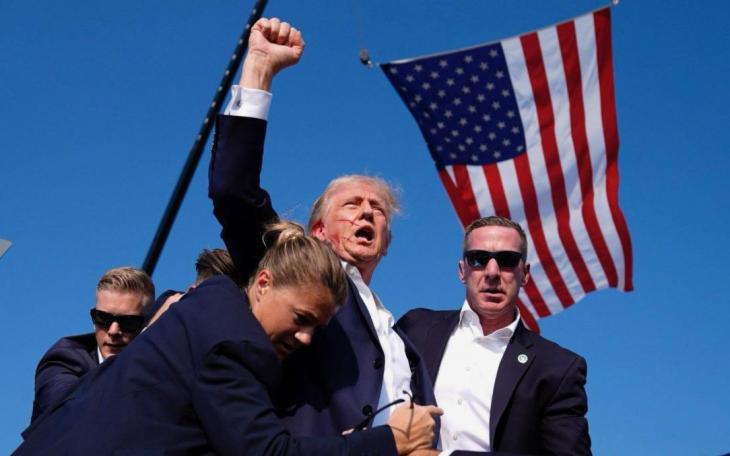 President Donald Trump minutes after a would-be assassin shot at him and grazed the right ear.