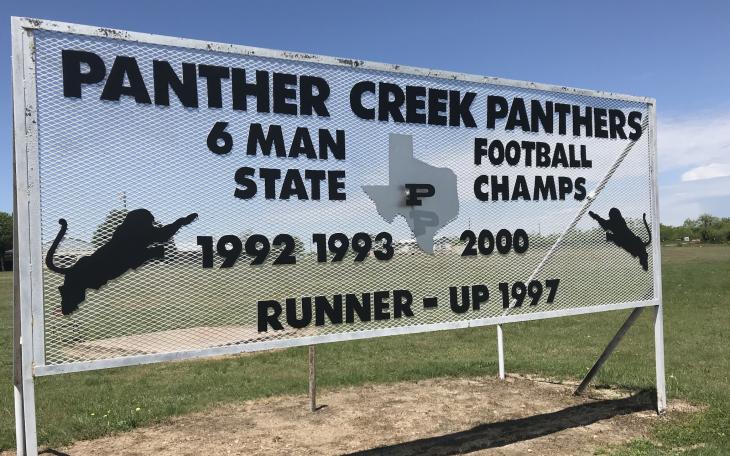 A sign at Panther Creek High School displays the football program's accomplishments.