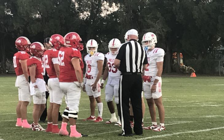 The captains for Miles and Albany meet for the coin toss Friday, Oct. 11, 2024, in Albany.