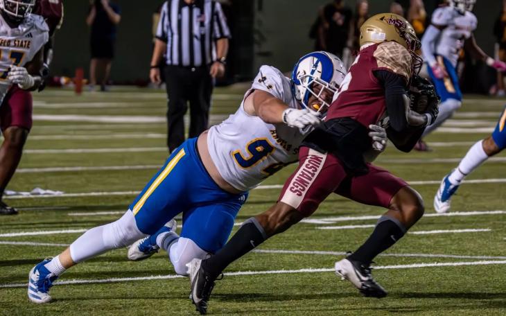 Angelo State's Owen Seaver brings down a Midwestern State player Saturday, Oct. 19, 2024, at Memorial Stadium in Wichita Falls.
