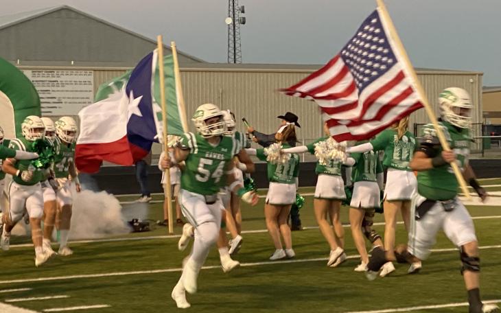 The Wall Hawks football team charges onto the field before its first-round playoff game with Anthony on Friday, Nov. 15, 2024.